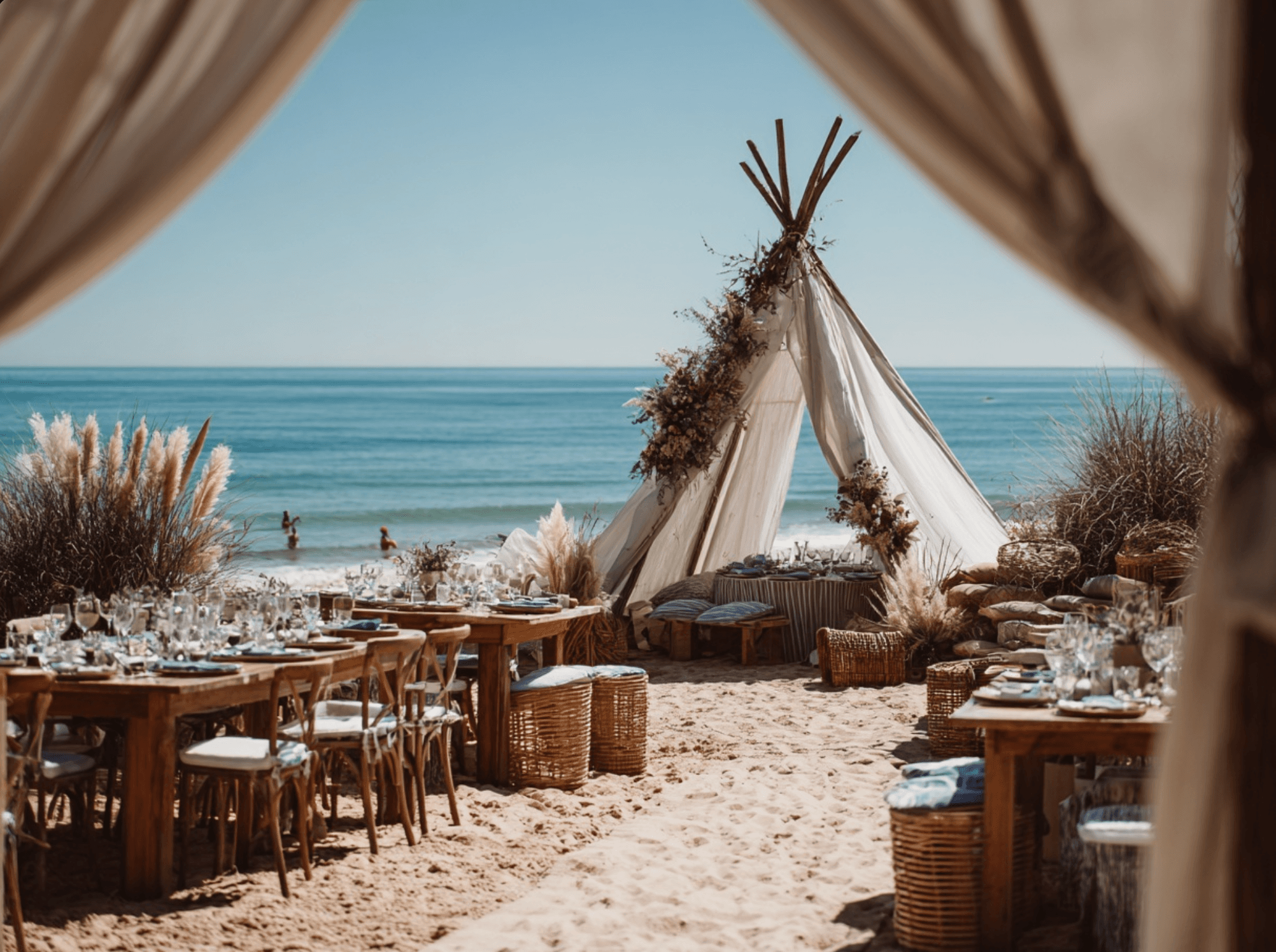 Boho beach wedding setup with natural textiles and ocean view